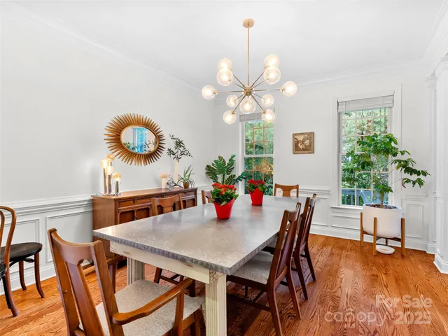 a view of a dining room with furniture and chandelier