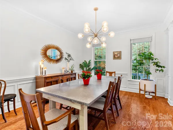 a view of a dining room with furniture and chandelier