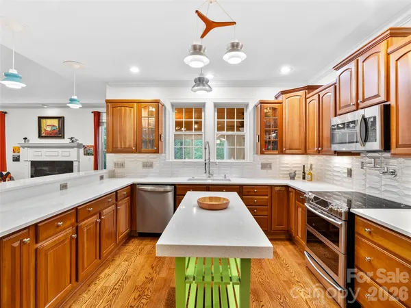 a kitchen with stainless steel appliances granite countertop a sink stove and cabinets