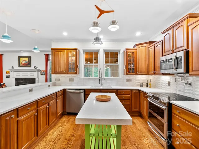 a kitchen with stainless steel appliances granite countertop a sink stove and cabinets
