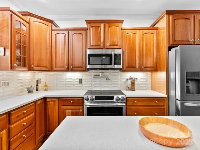 a kitchen with stainless steel appliances granite countertop a stove top oven a sink dishwasher and a microwave