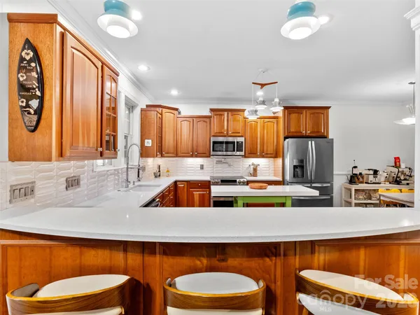 a kitchen with a sink stove and a granite counter top space