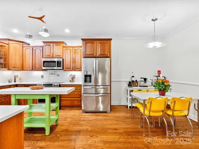 a kitchen with stainless steel appliances granite countertop a stove refrigerator and microwave