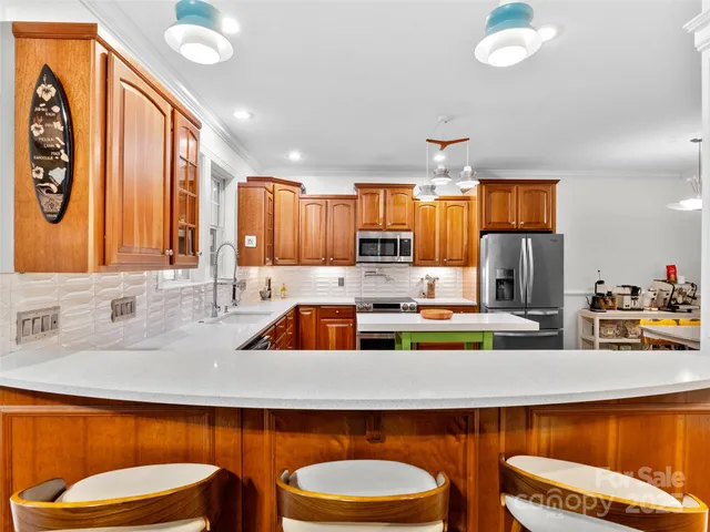 a kitchen with a sink stove and a granite counter top space
