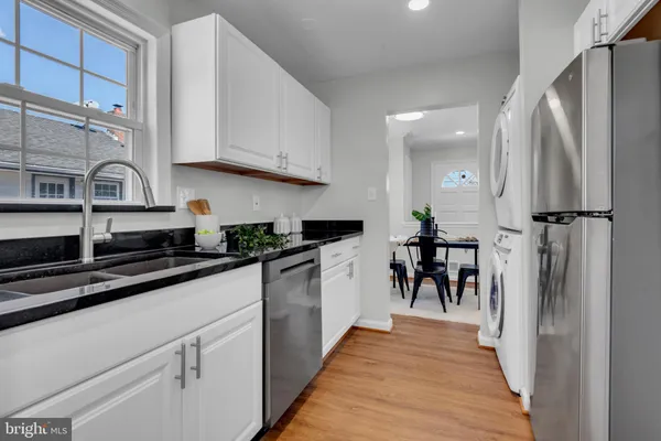 a kitchen with stainless steel appliances granite countertop a refrigerator and a stove top oven