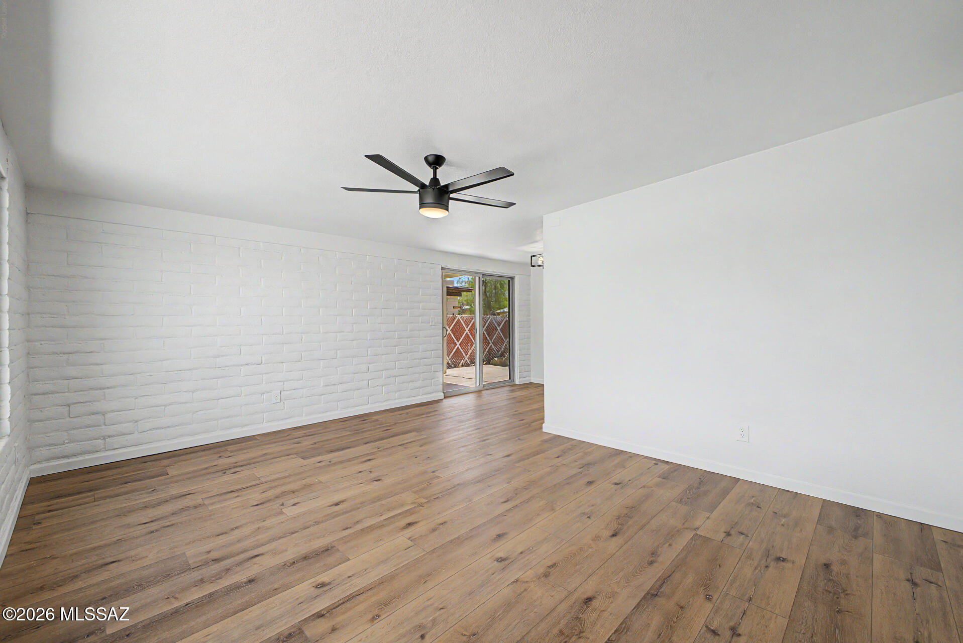 3402 South Kolb Road Tucson, AZ 85730 - Photo 6 of 32 a view of empty room with wooden floor and ceiling fan