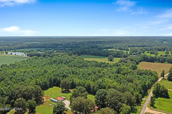 an aerial view of a houses with a yard
