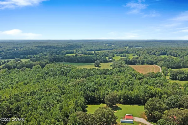 an aerial view of a houses with a yard
