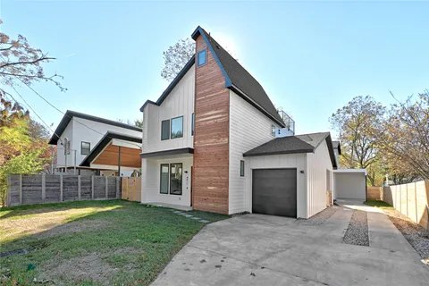 a view of a house with a yard and garage