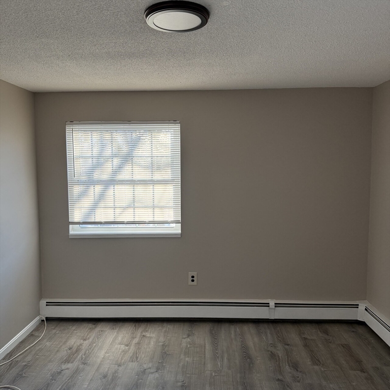 509 Chatham Street, Unit C Lynn, MA 01902 - Photo 5 of 9 an empty room with a window