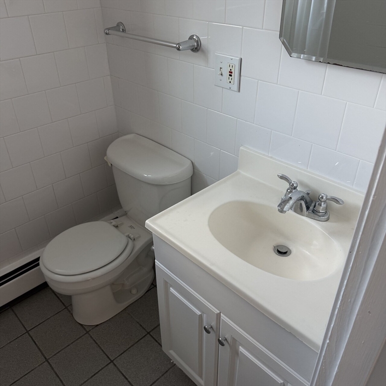 509 Chatham Street, Unit C Lynn, MA 01902 - Photo 9 of 9 a white toilet sitting next to a bathroom sink