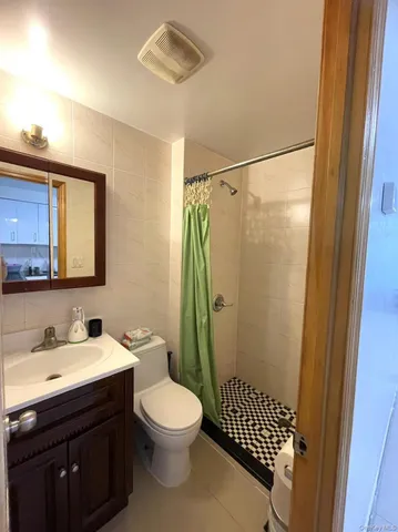 a bathroom with a toilet a sink and a mirror