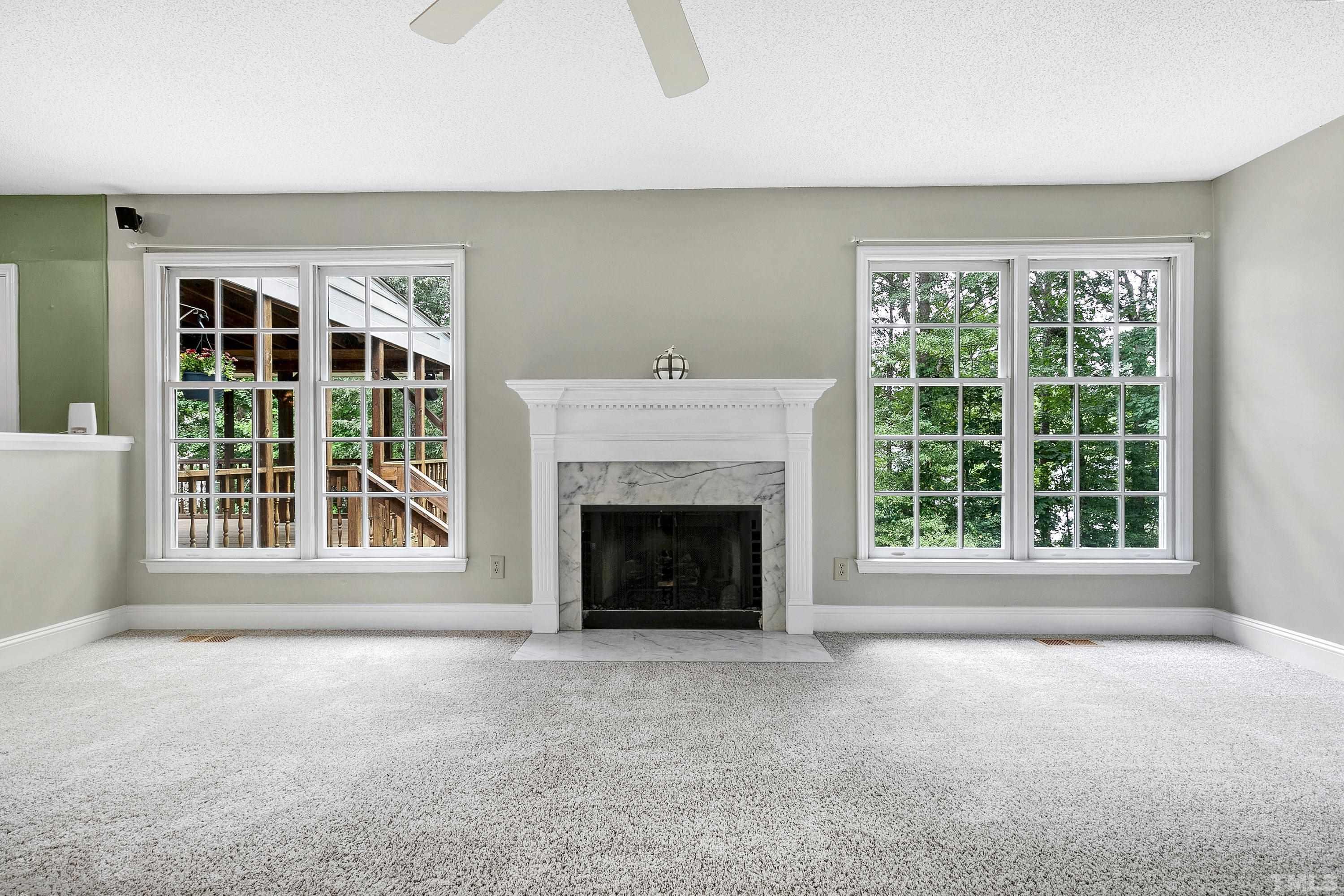 117 Trailing Oak Cary, NC 27513 - Photo 11 of 32 a view of an empty room with a fireplace and a window