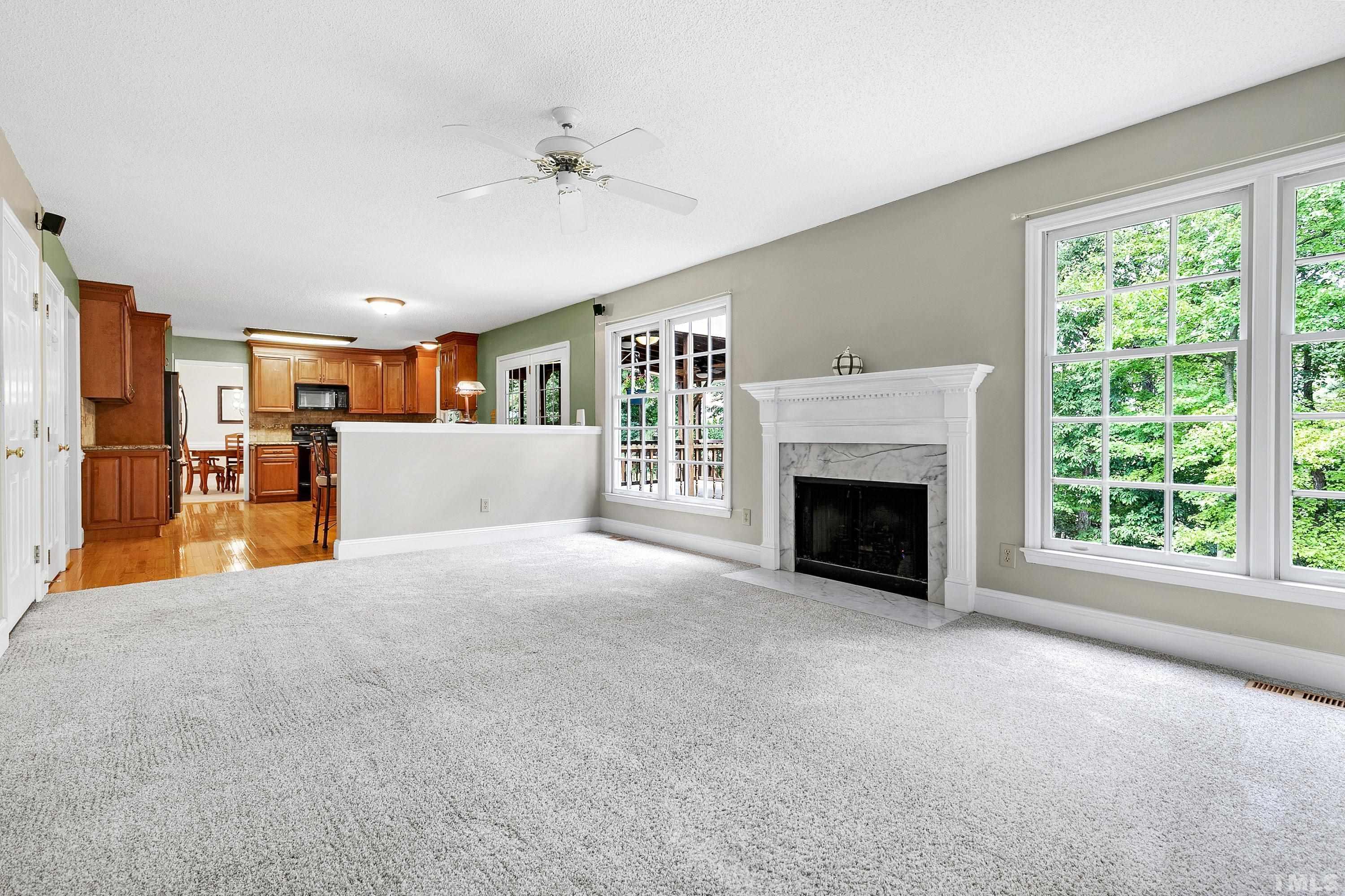 117 Trailing Oak Cary, NC 27513 - Photo 12 of 32 a view of a livingroom with an empty space and a fireplace