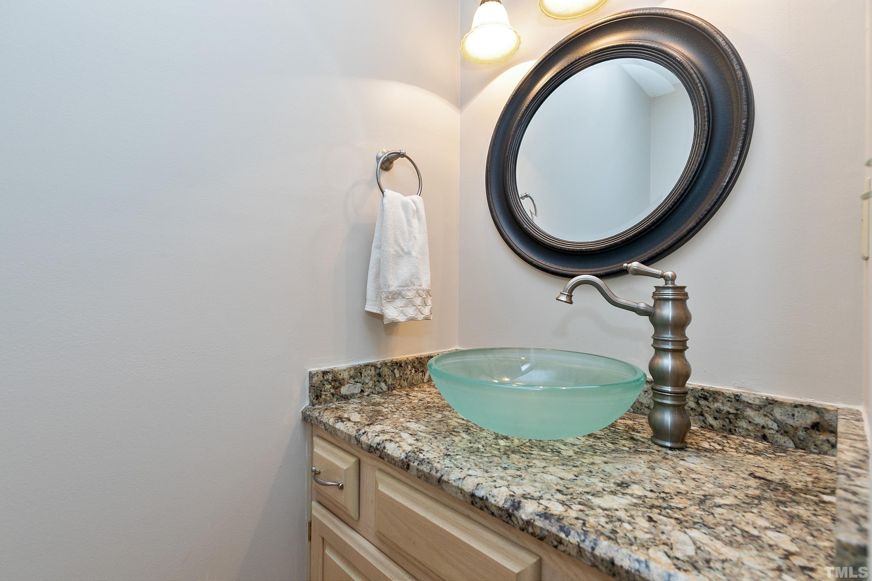 117 Trailing Oak Cary, NC 27513 - Photo 13 of 32 a bathroom with a granite countertop sink and a mirror