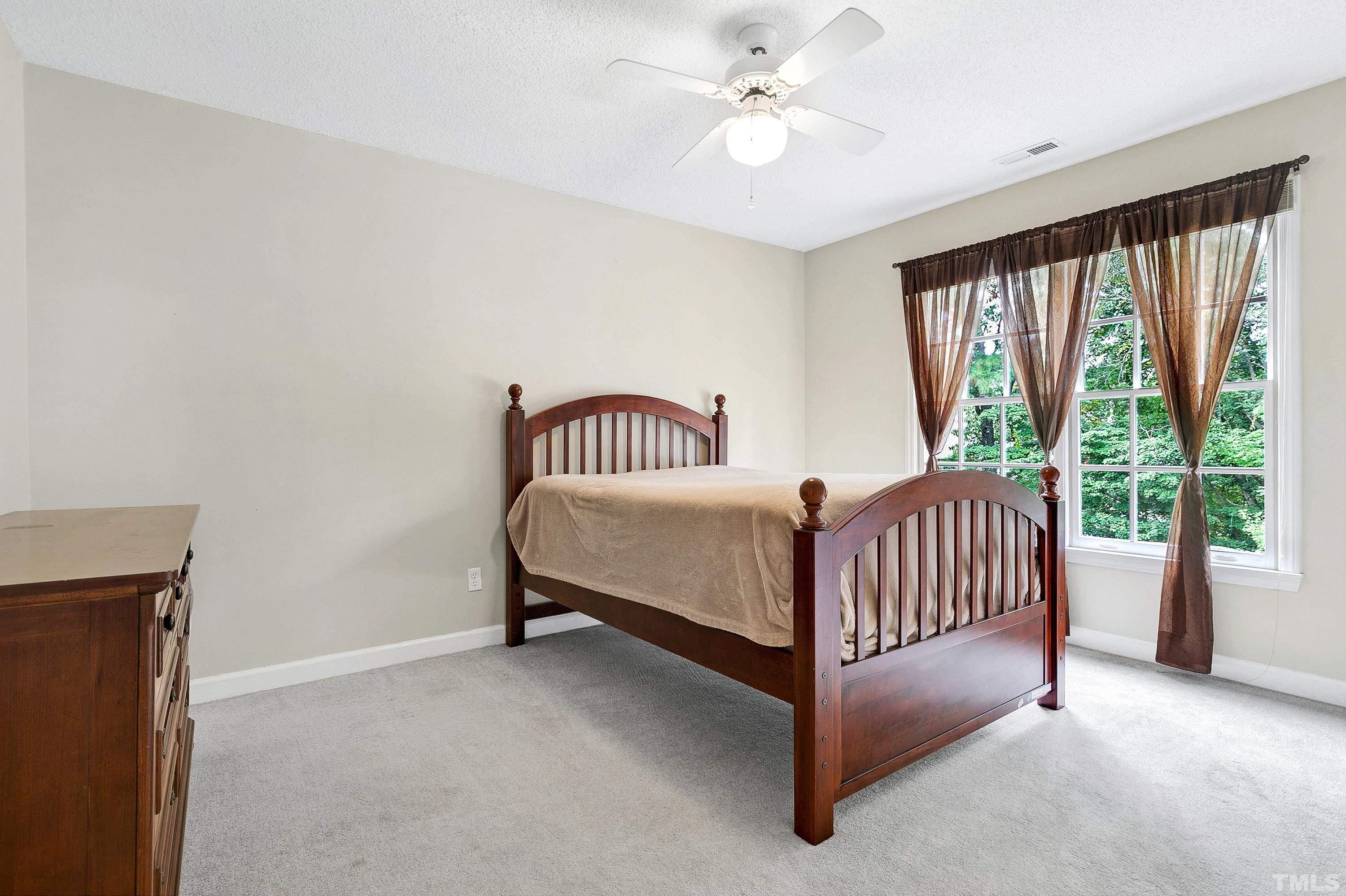 117 Trailing Oak Cary, NC 27513 - Photo 18 of 32 a bedroom with a bed and a large window