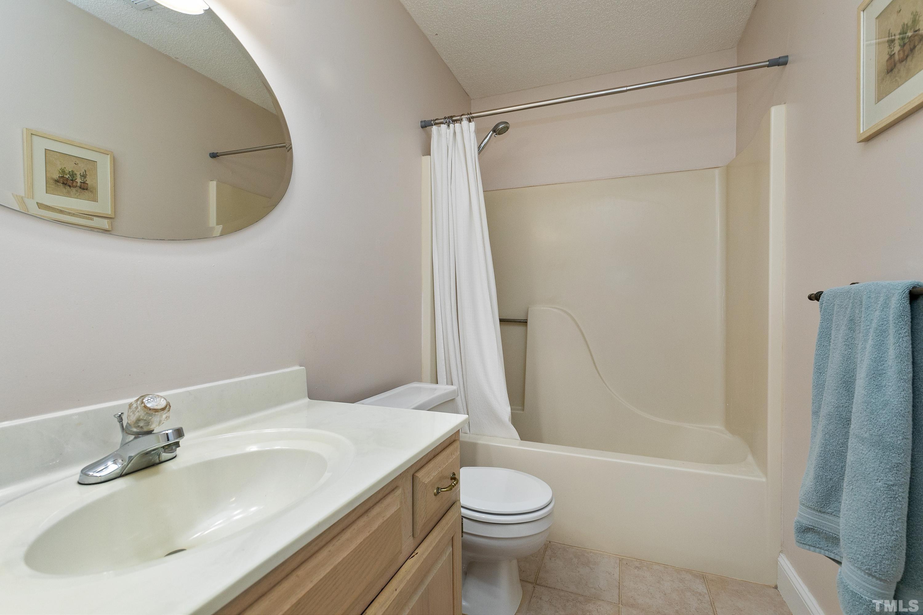 117 Trailing Oak Cary, NC 27513 - Photo 19 of 32 a bathroom with a sink toilet and shower