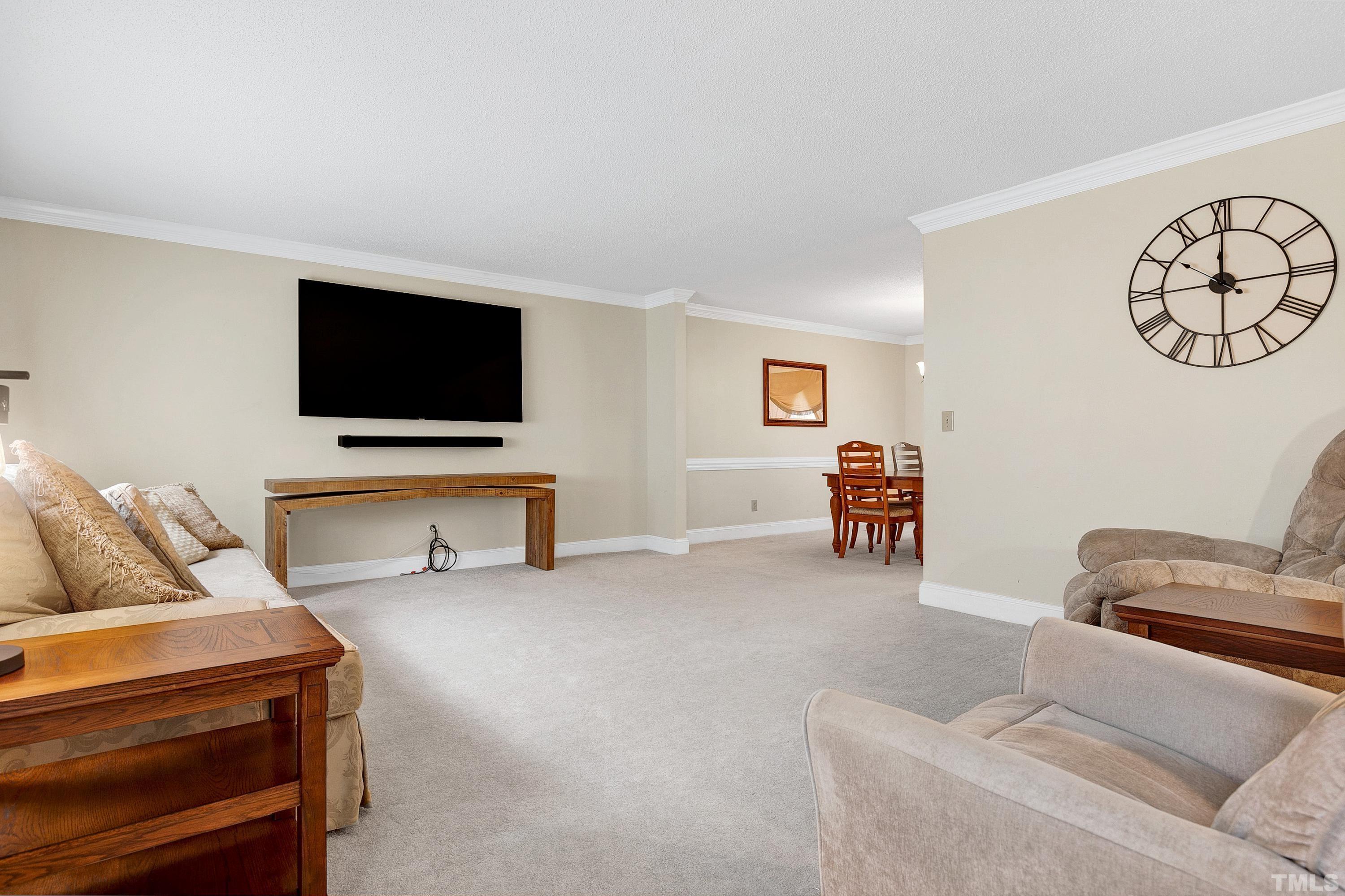 117 Trailing Oak Cary, NC 27513 - Photo 2 of 32 a living room with furniture and a flat screen tv
