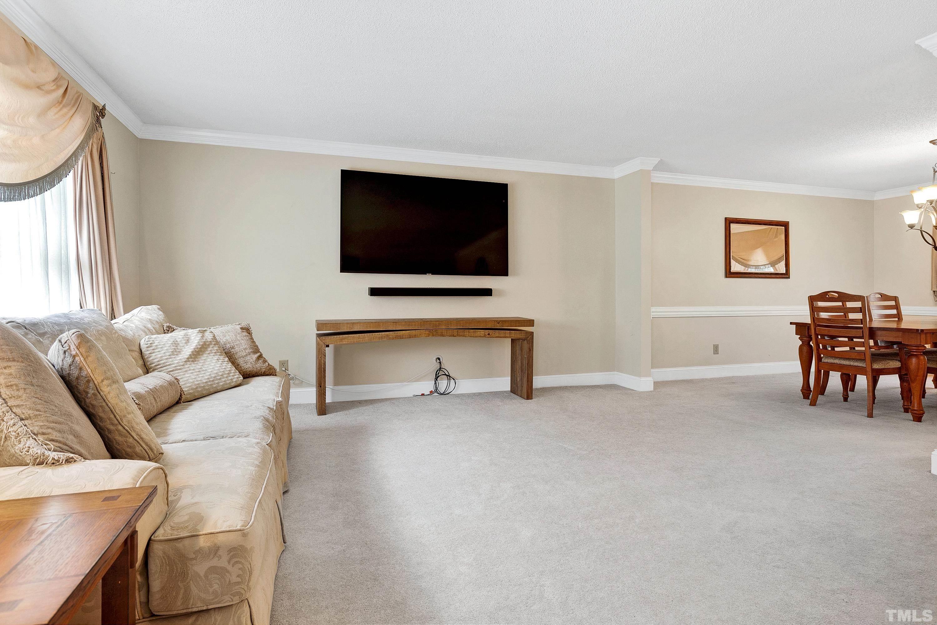 117 Trailing Oak Cary, NC 27513 - Photo 3 of 32 a living room with furniture and a flat screen tv