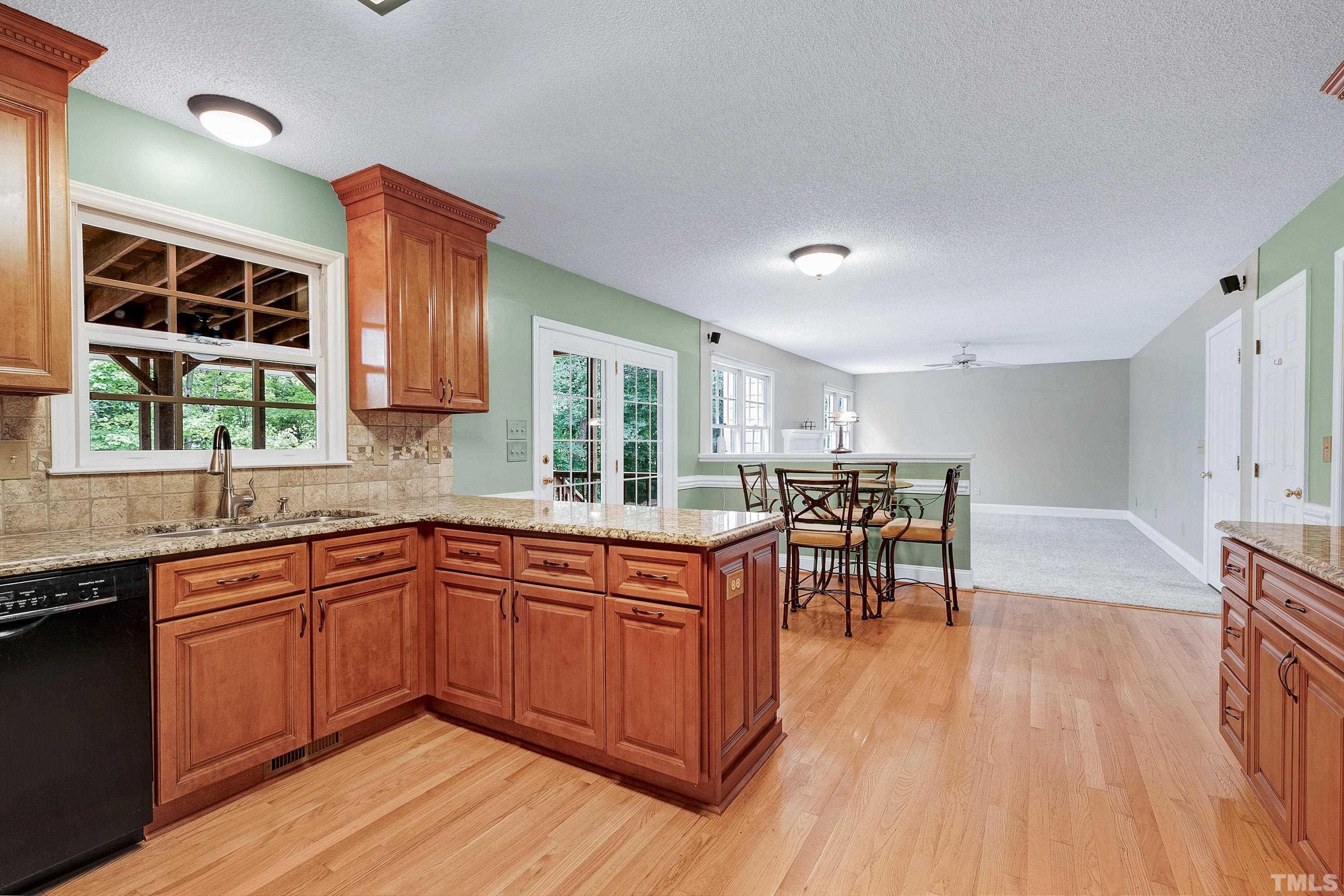 117 Trailing Oak Cary, NC 27513 - Photo 6 of 32 a kitchen with wooden floors and wooden cabinets