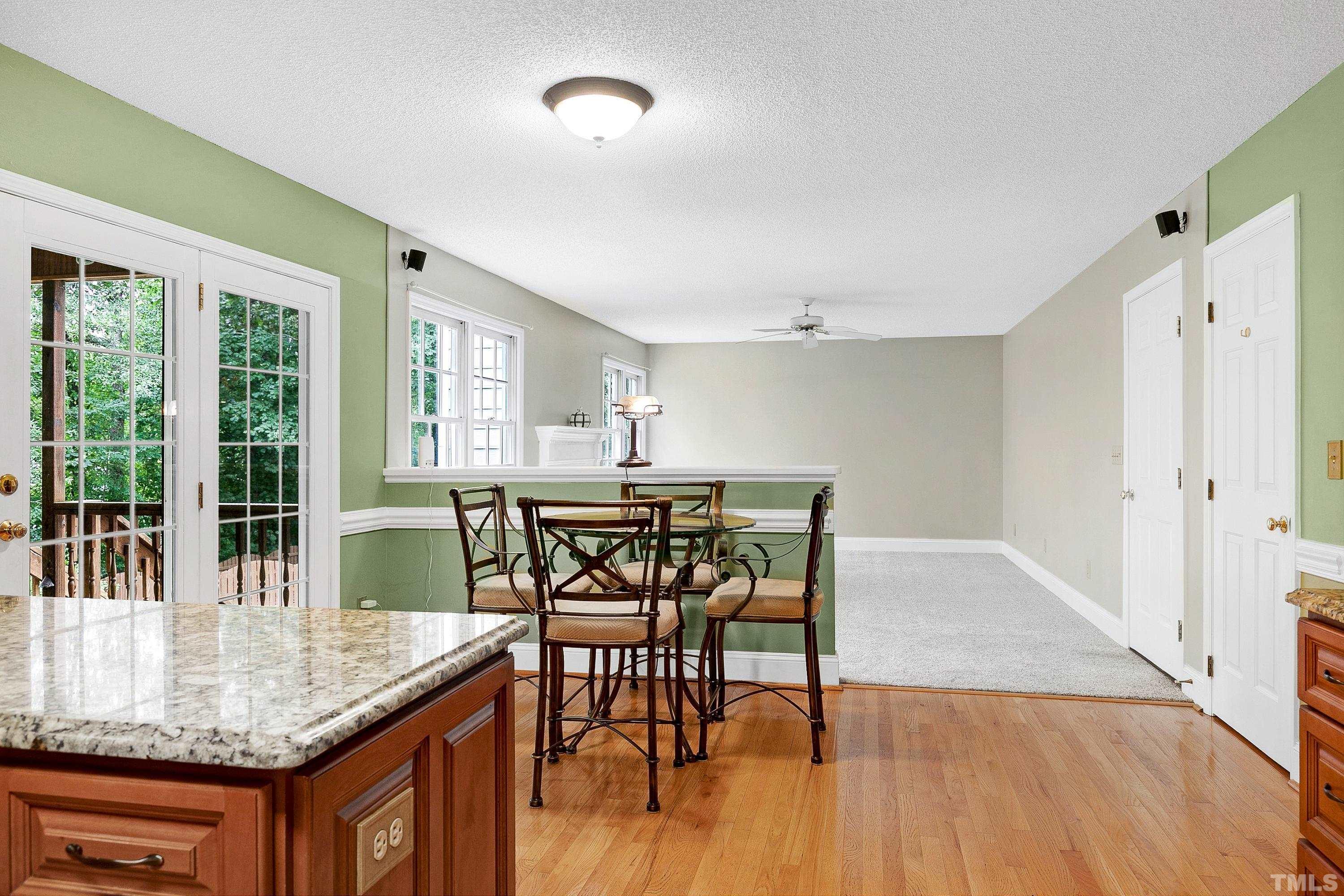 117 Trailing Oak Cary, NC 27513 - Photo 7 of 32 a dining room with furniture and wooden floor