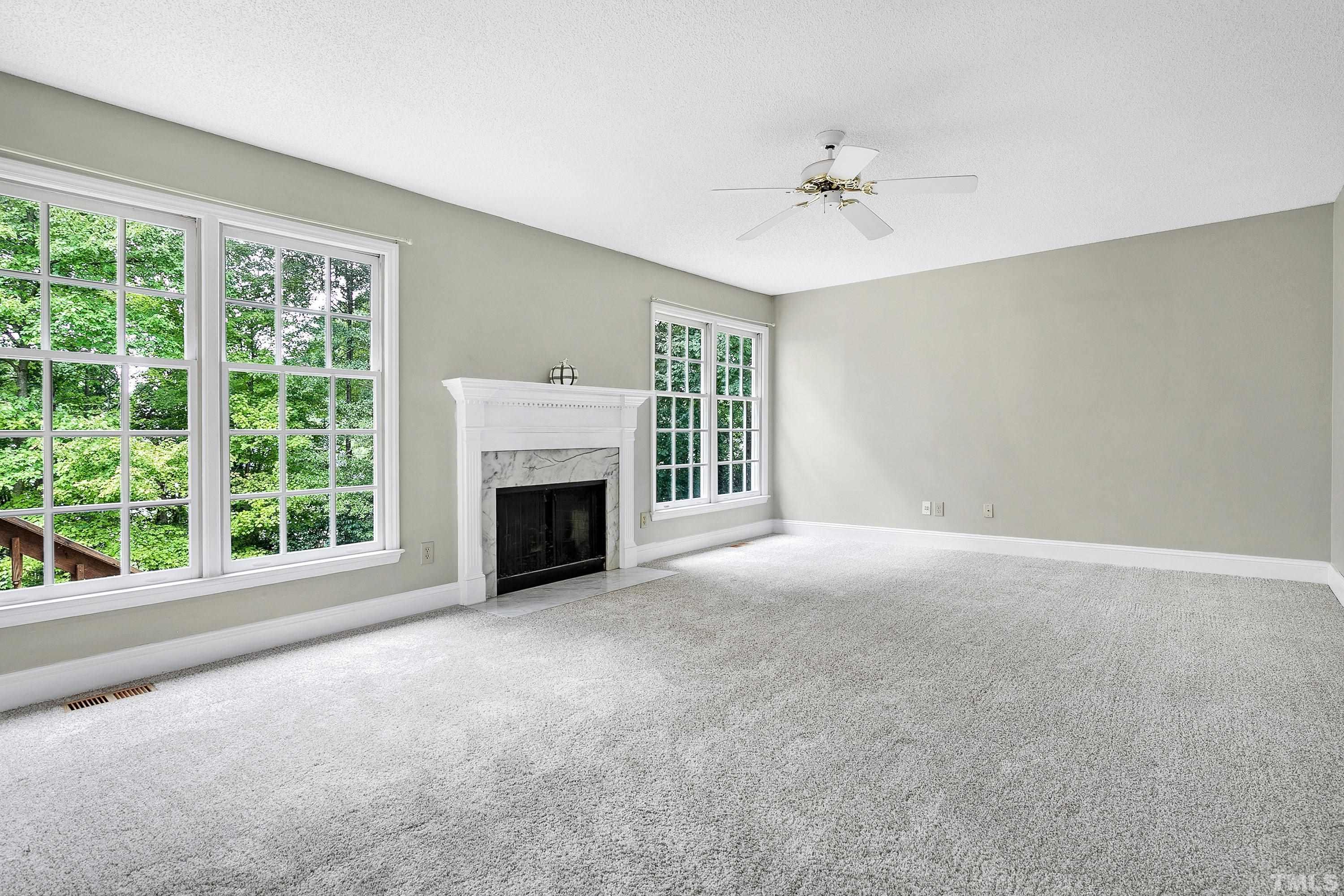 117 Trailing Oak Cary, NC 27513 - Photo 10 of 32 a view of an empty room with a fireplace and a window