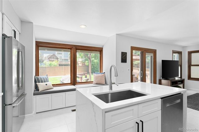 a kitchen with a sink and wide window
