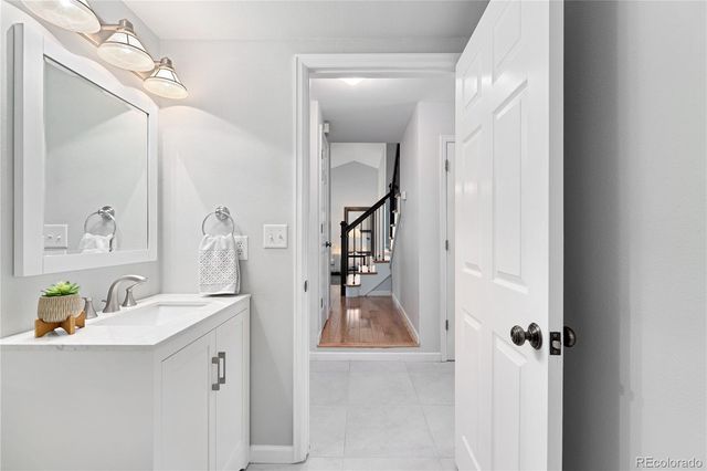 a bathroom with a sink vanity and mirror
