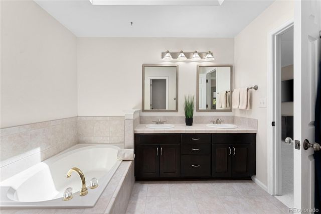 a spacious bathroom with a granite countertop sink and a mirror