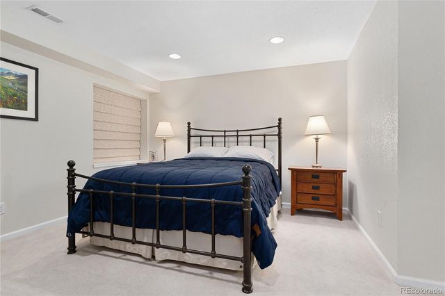 a bedroom with a bed and a lamp