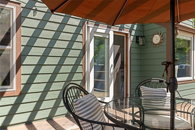 a view of deck with furniture and umbrella