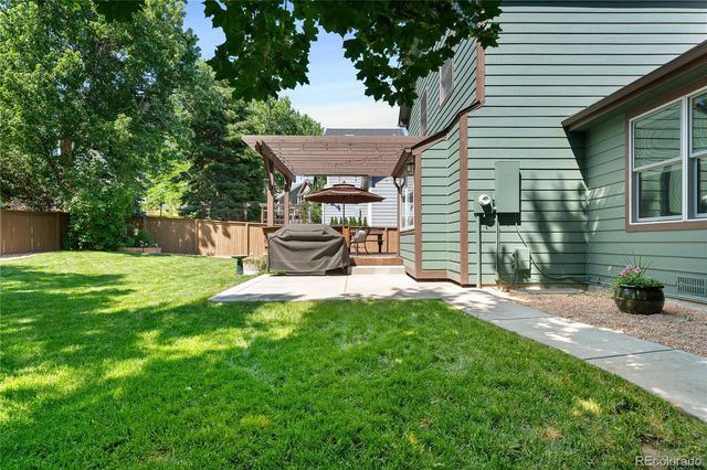 an aerial view of a house with garden space and trees