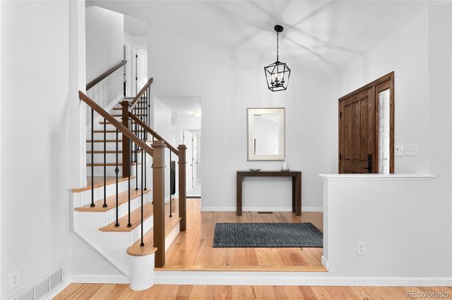a view of entryway and hall with wooden floor