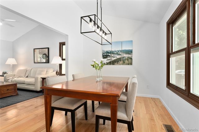 a view of a dining room with furniture and a window