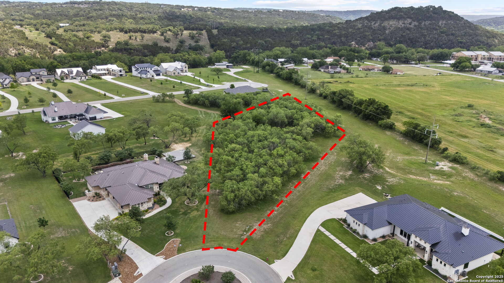 an aerial view of residential houses with outdoor space and river