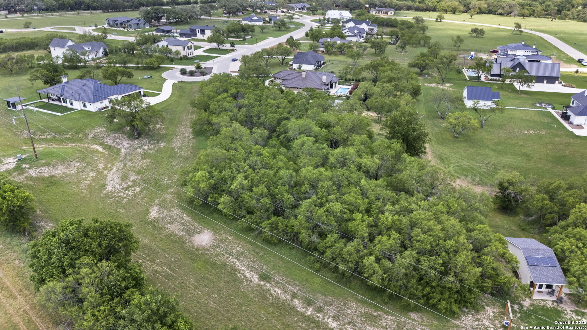 831 Wade Road New Braunfels, TX 78132 - Photo 11 of 35 an aerial view of residential houses with outdoor space and trees