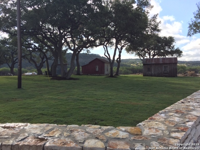 831 Wade Road New Braunfels, TX 78132 - Photo 15 of 35 a backyard of a house with lots of green space and fountain