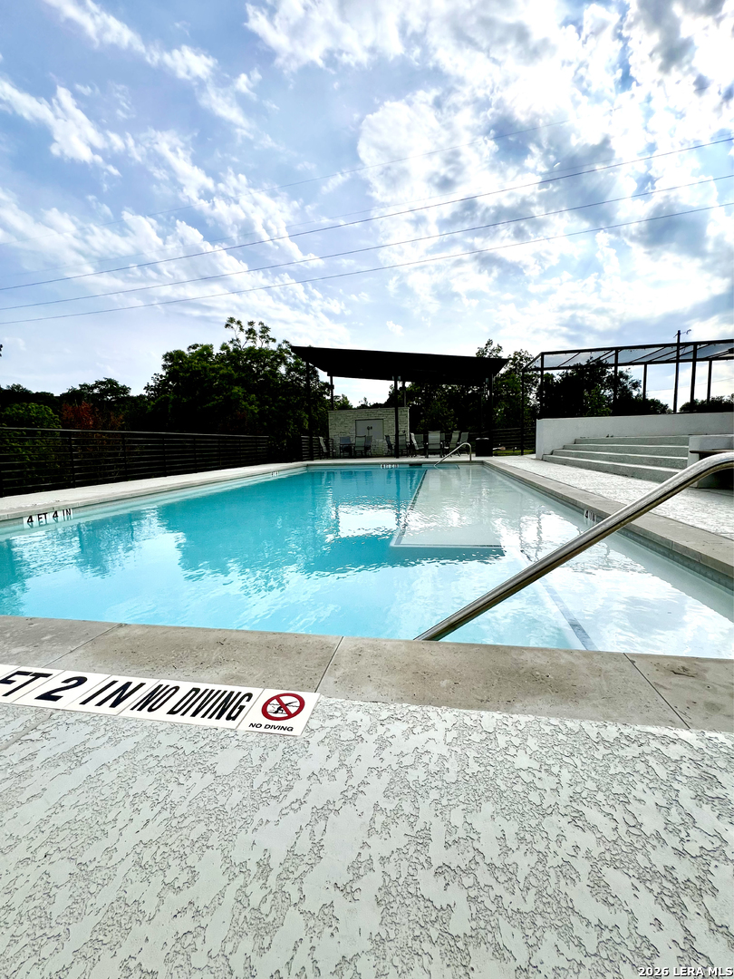 831 Wade Road New Braunfels, TX 78132 - Photo 27 of 35 a view of a pool with a yard in back