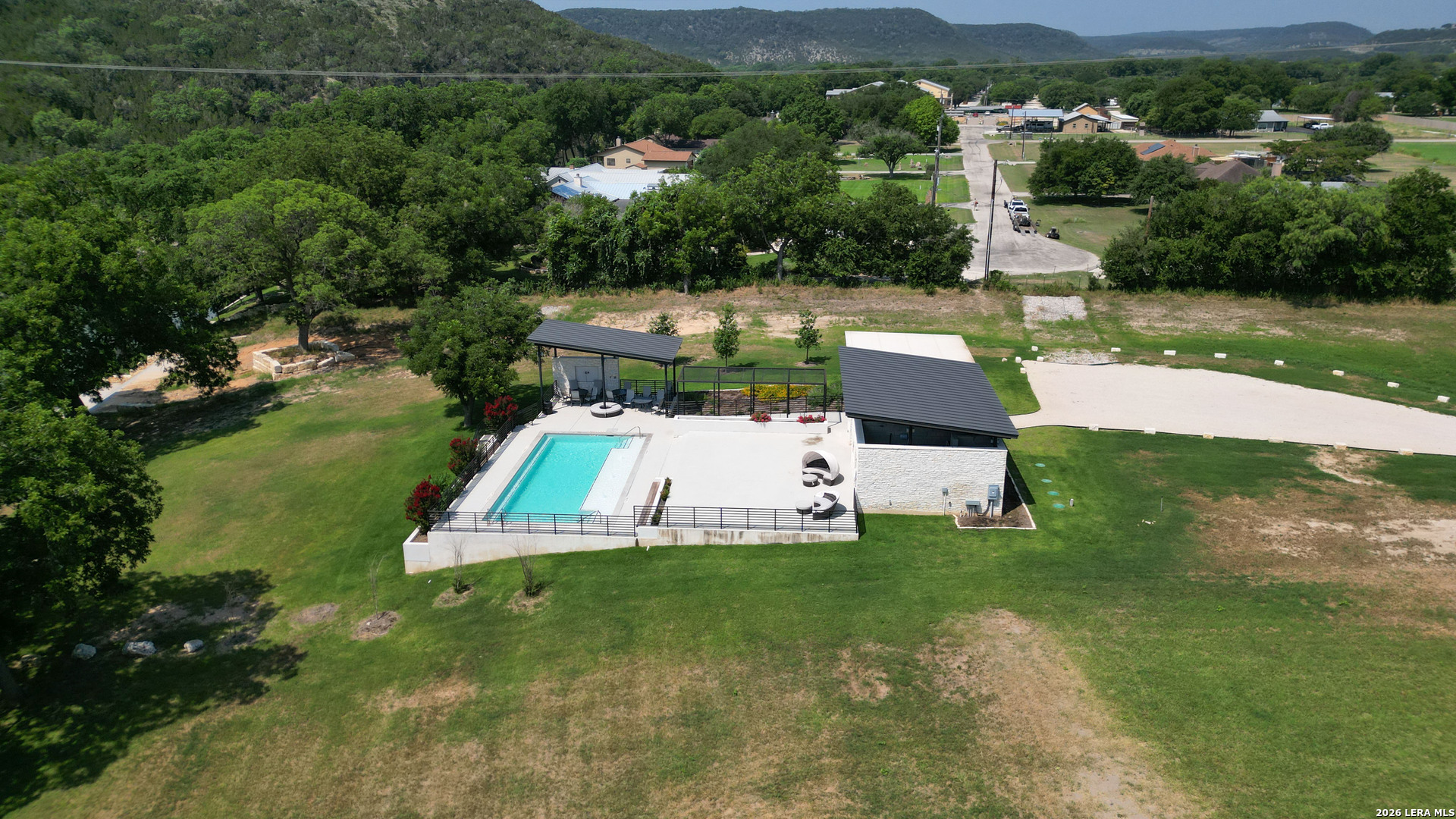 831 Wade Road New Braunfels, TX 78132 - Photo 28 of 35 an aerial view of a house with pool lake view and mountain view