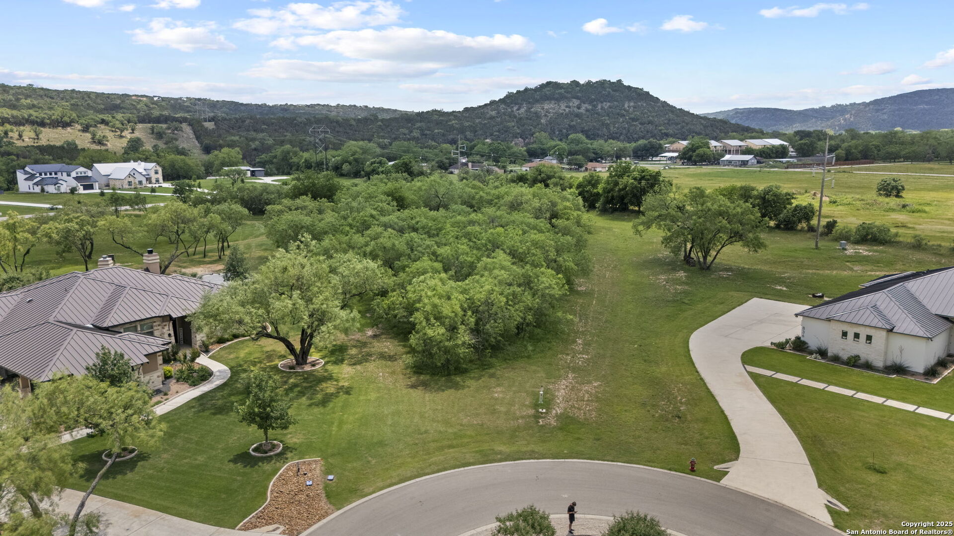 831 Wade Road New Braunfels, TX 78132 - Photo 8 of 35 an aerial view of a house with a garden and lake view