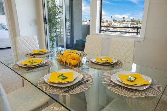 a kitchen with a sink white cabinets and stainless steel appliances
