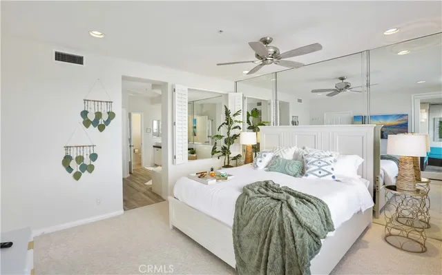 a bathroom with double vanity sinks a large mirror and a bathtub