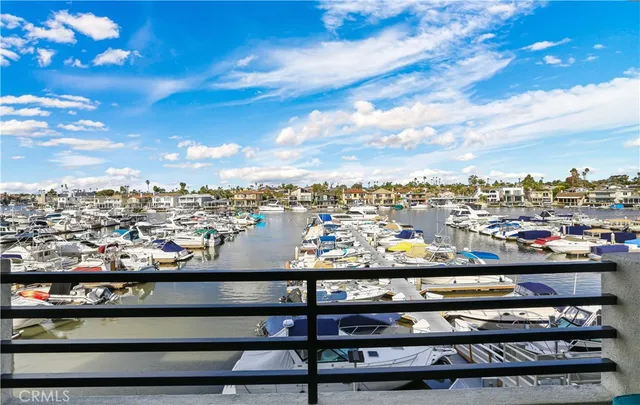 a living room with furniture kitchen view and a chandelier