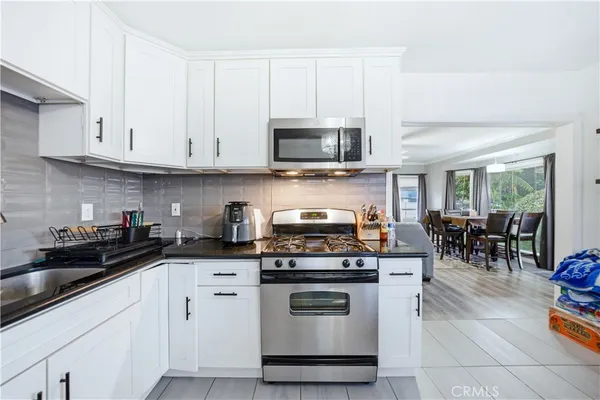 a kitchen with stainless steel appliances a stove a sink a stove a microwave and cabinets