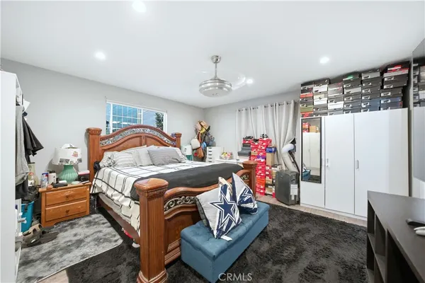 a bedroom with bed and a chandelier