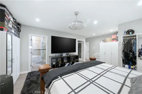 a bedroom with a bed and a flat screen tv