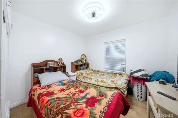 a bedroom with two bed and a dresser