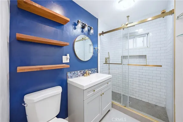 a bathroom with a toilet a sink and mirror