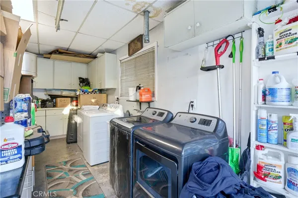 a utility room with sink dryer and washer