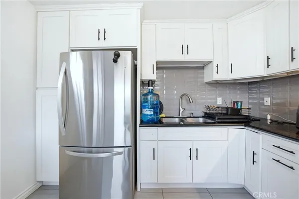 a kitchen with appliances a sink and cabinets